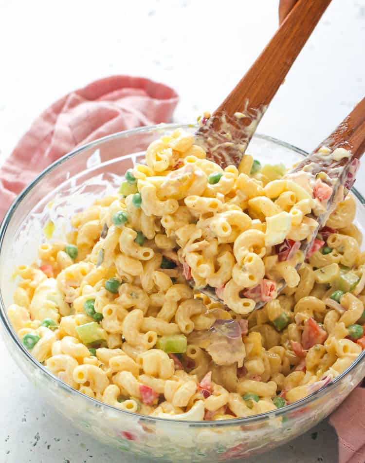 Mixing a big bowl of macaroni salad.