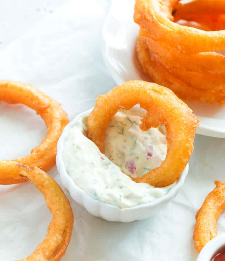 Beer Battered Onion Rings dipped in tartar sauce