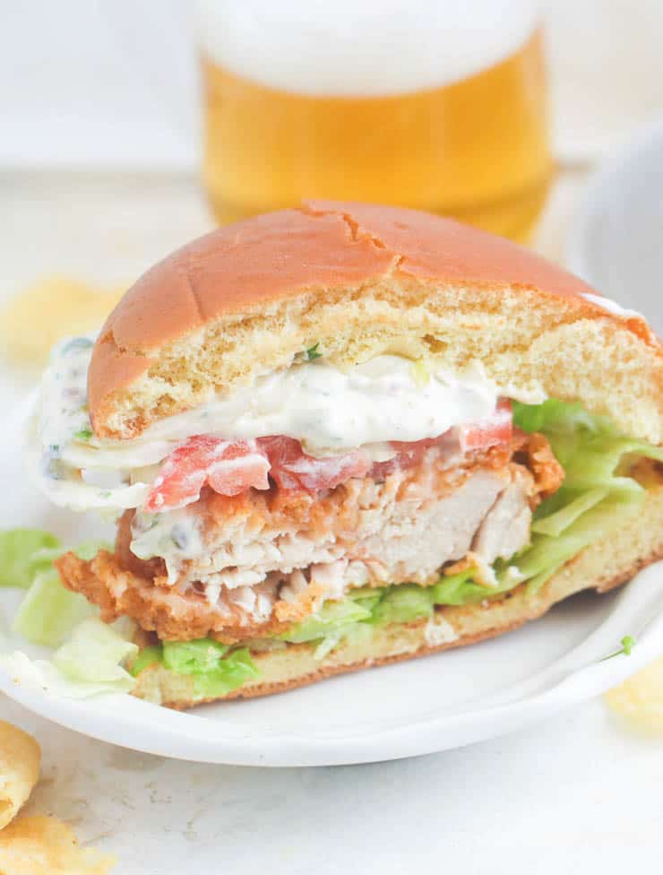 Chicken Sandwich with tartar sauce or remoulade cut in half and ready to devour