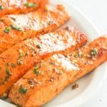 Broiled Salmon on a white platter ready to enjoy