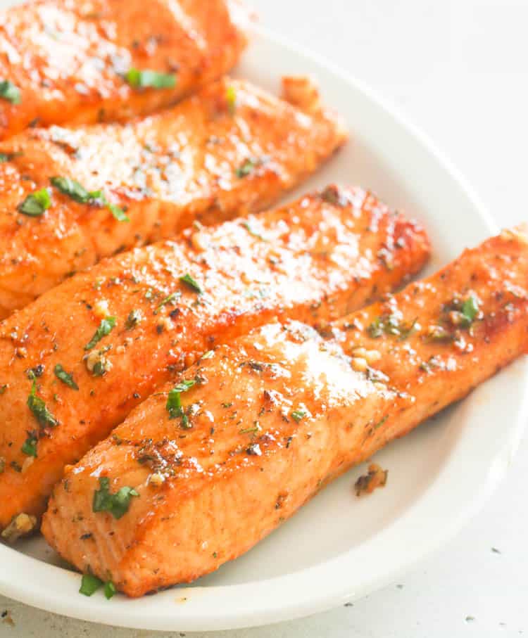 Broiled Salmon on a white platter ready to enjoy