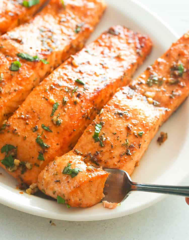 Taking a bite of delicious Broiled Salmon