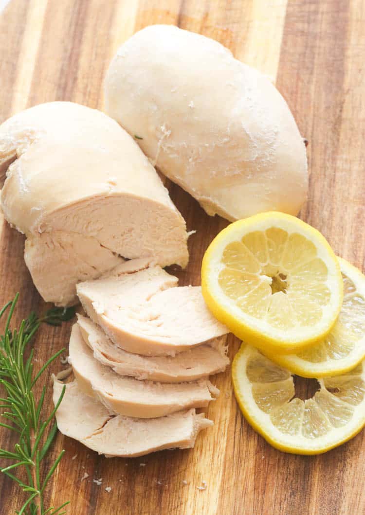 Poached Chicken with Rosemary and Lemon on a Cutting Board