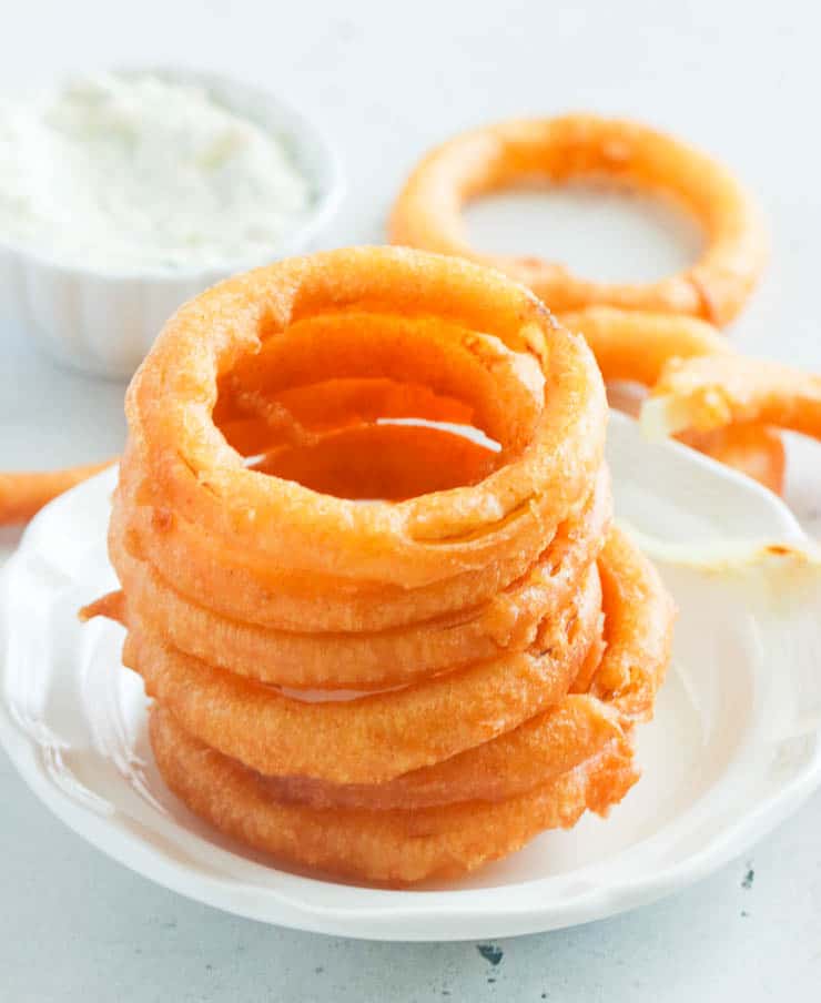 A crispy stack of Beer Battered Onion Ring ready for the Super Bowl