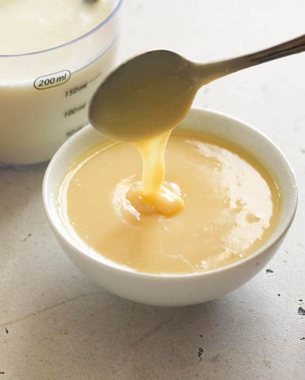 a small clear bowl with condensed milk