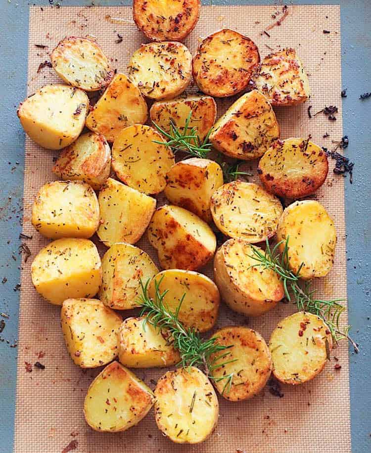 Taking the roasted potatoes out of the oven.
