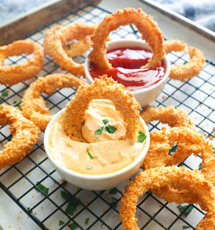 Onion Rings fresh from the air fryer with remoulade and ketchup