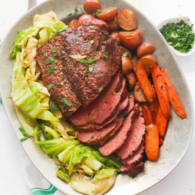 A Platter of Sliced Corned Beef and Cabbage with Carrots and Potatoes