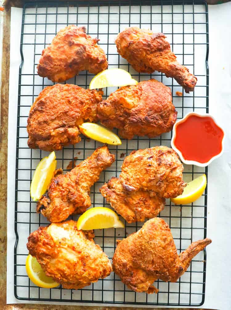 Air Fryer Southern Fried Chicken in a cooling rack with lemon wedges