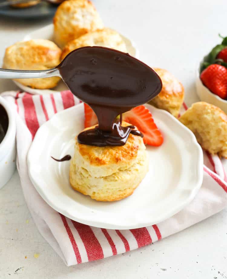 drizzling chocolate over a biscuit