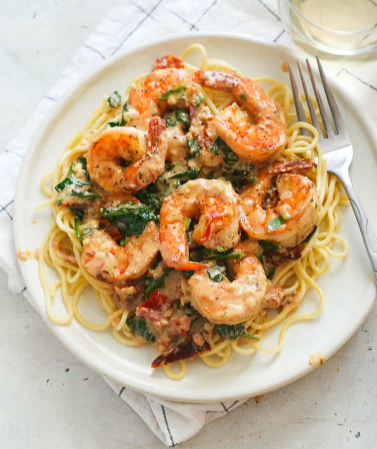 Tuscan Shrimp Served Over Cooked Pasta