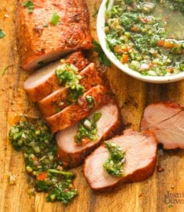 Smoked pork tenderloin drizzled with chimichurri