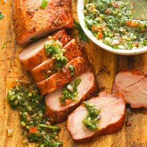 Smoked pork tenderloin drizzled with chimichurri
