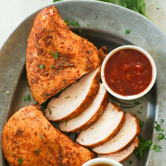 smoked chicken breast slices with sauces on a plate