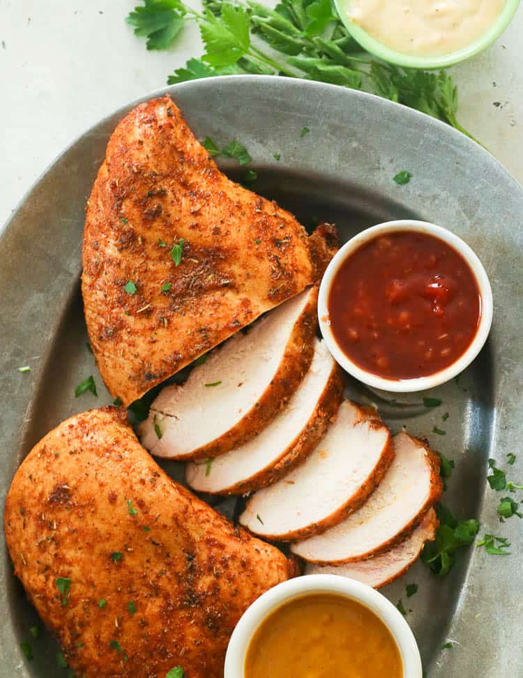 smoked chicken breast slices with sauces on a plate
