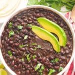 cooked black beans with slices of avocado