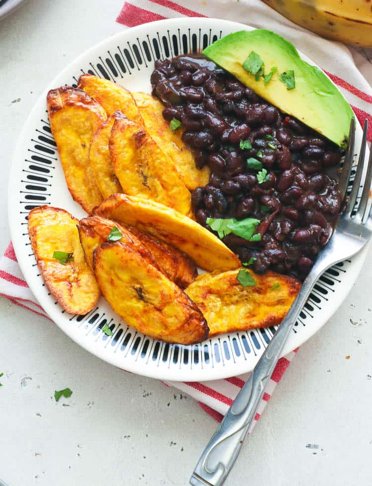 black beans with plantains and avocado on a plate