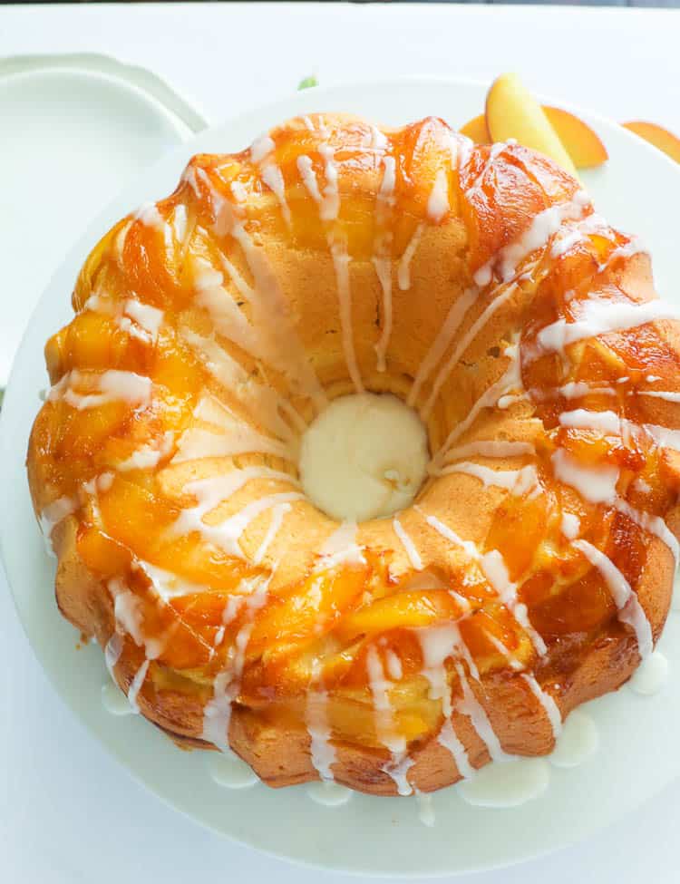 A whole peach cake with vanilla drizzle