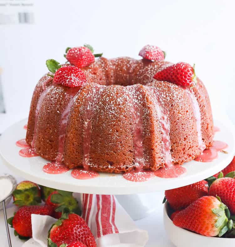 Strawberry Pound Cake on a Cake Stand Drizzled with Strawberry Sauce