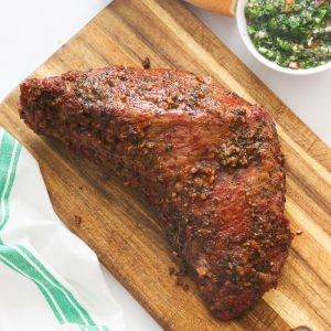 Whole marinated smoked meat on a chopping board