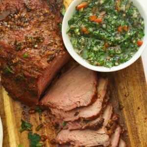 smoked beef on a chop board with marinade ingredients