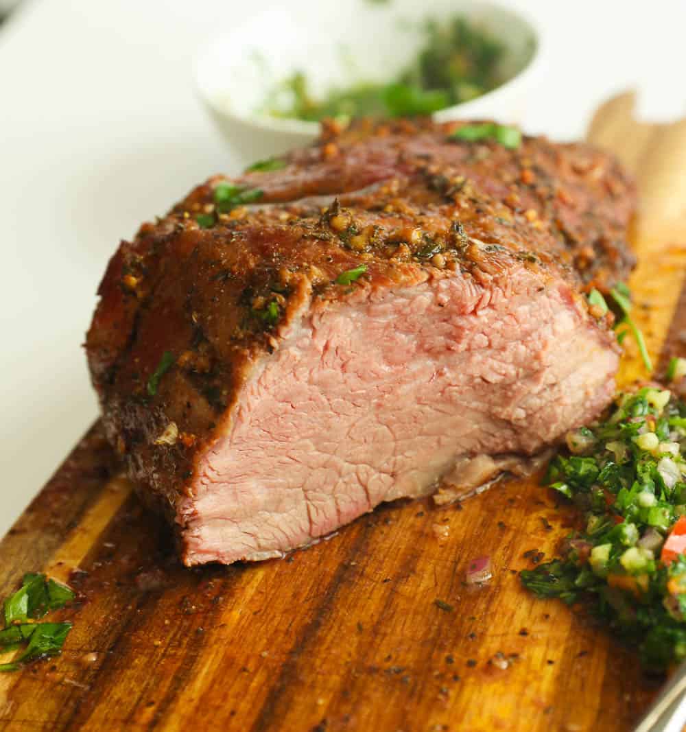 Cross cut of smoked tri tip on a chopping board