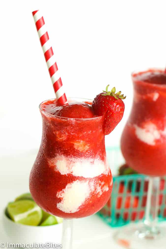 Strawberry Daiquiri on a fancy glass with red and white stripes straw