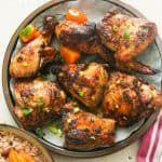6 pieces of insanely delicious jerk chicken on a plate