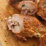 Sliced smoked turkey leg on a chopping board.