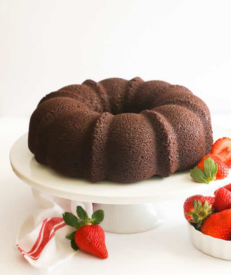 plain chocolate pound cake on a cake stand