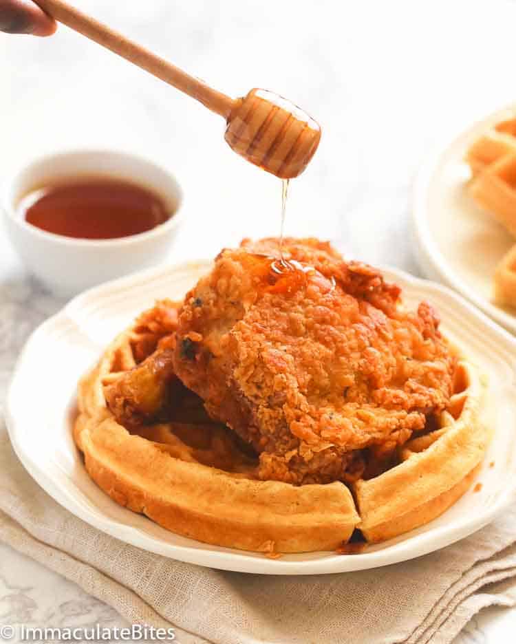 Chicken and Waffles drizzled with syrup, a classic Juneteenth breakfast.