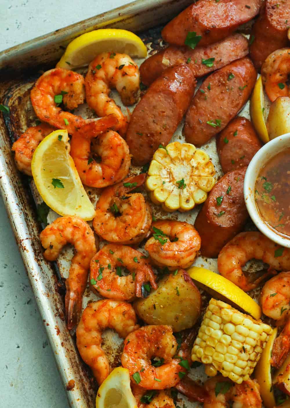 Cajun shrimp and sausage boil garnished with cilantro and lemon slices