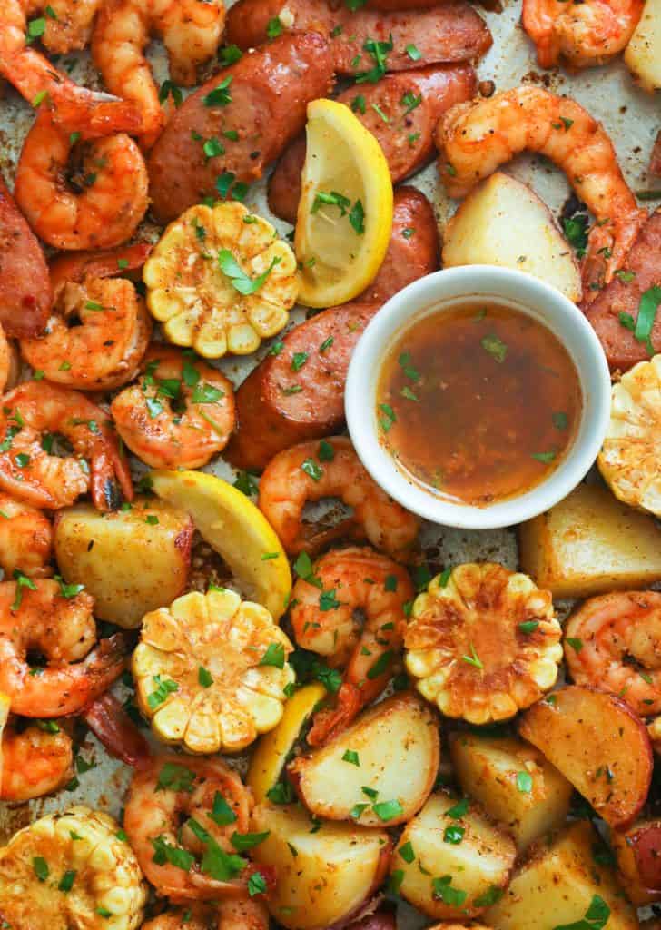 Cajun shrimp boil on a baking sheet with creole butter sauce