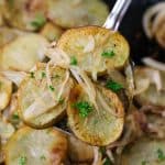 cooked potatoes and onions on a serving spoon