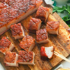chopped pork belly on a wooden chopping board