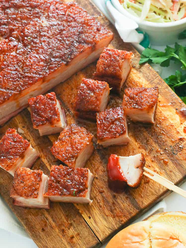 chopped pork belly on a wooden chopping board