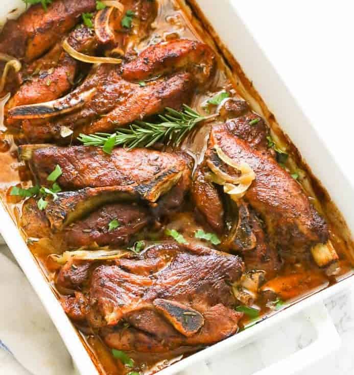 Country Style Ribs served in a pan topped with herbs