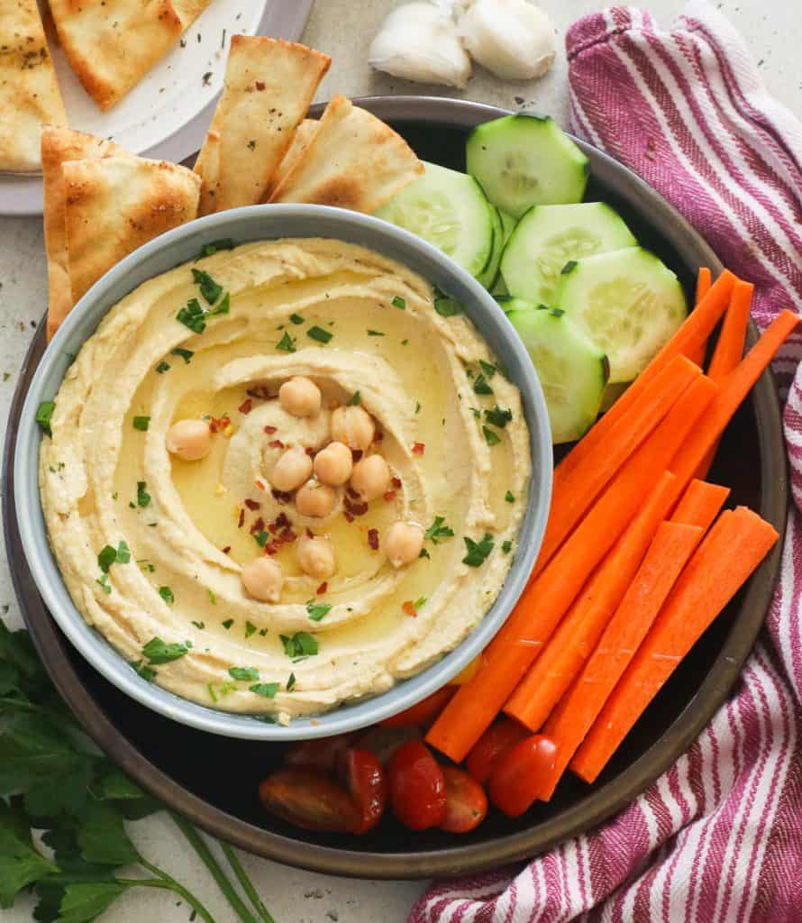 A Bowl of Hummus with Pita Chips and Veggies