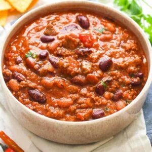 Chili Recipe loaded with beans in a white bowl
