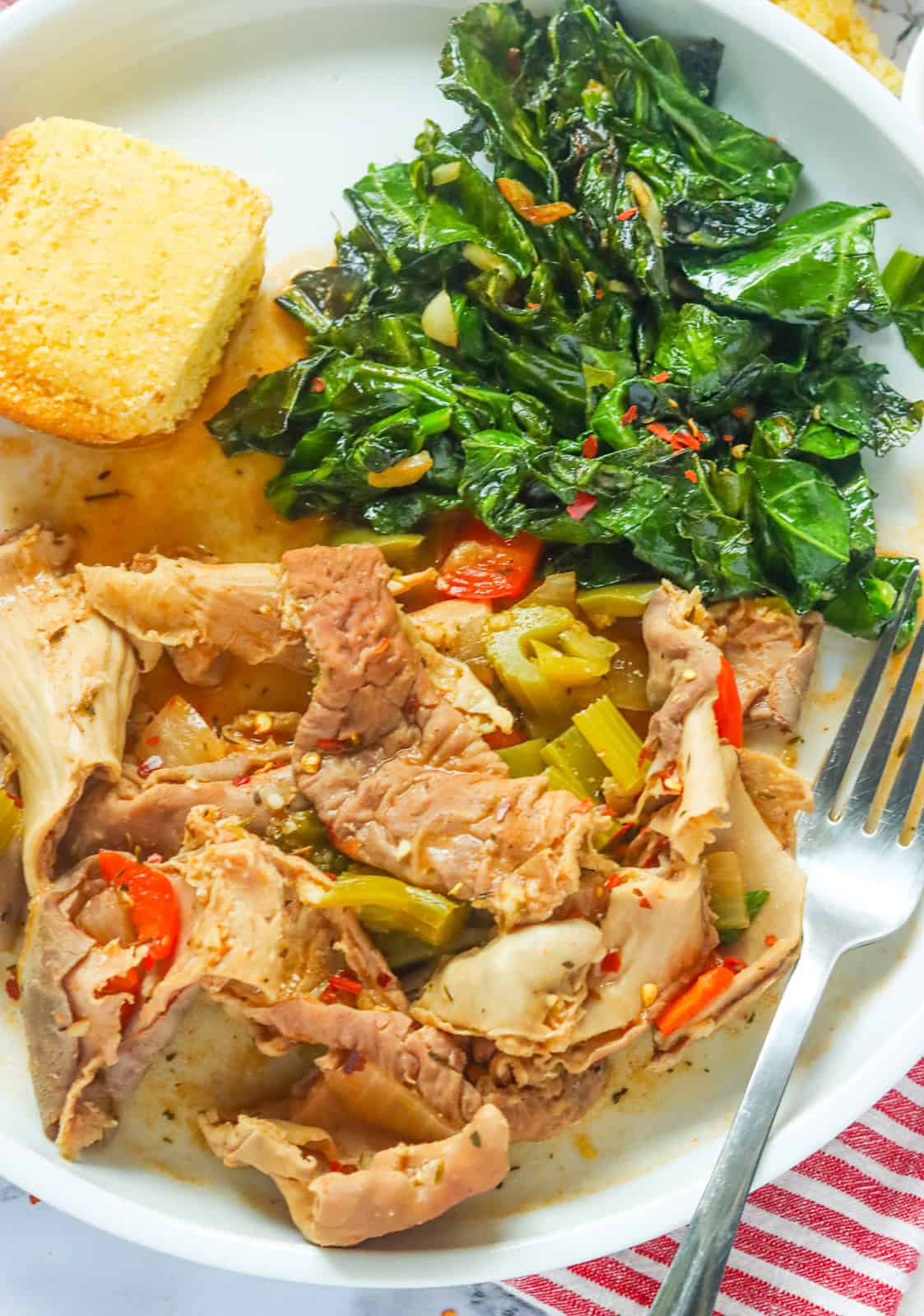 Enjoying traditional soul food with hog maws, cornbread, and collard greens.