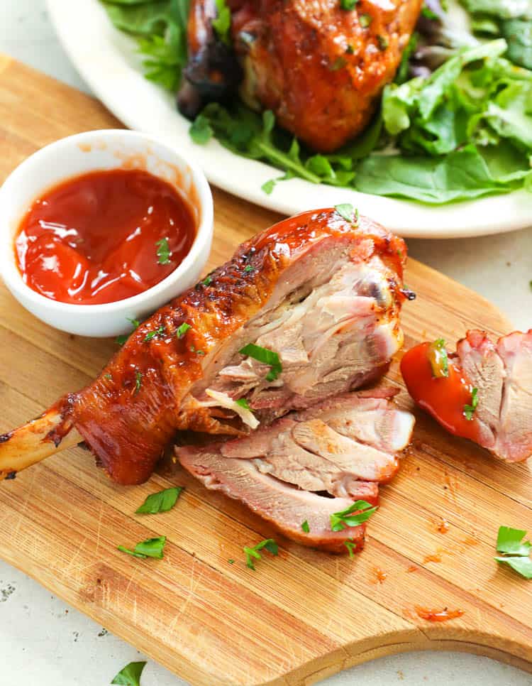 carved turkey leg on a chopping board
