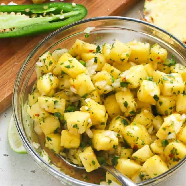 A Bowl of Pineapple Salsa with a Spoon