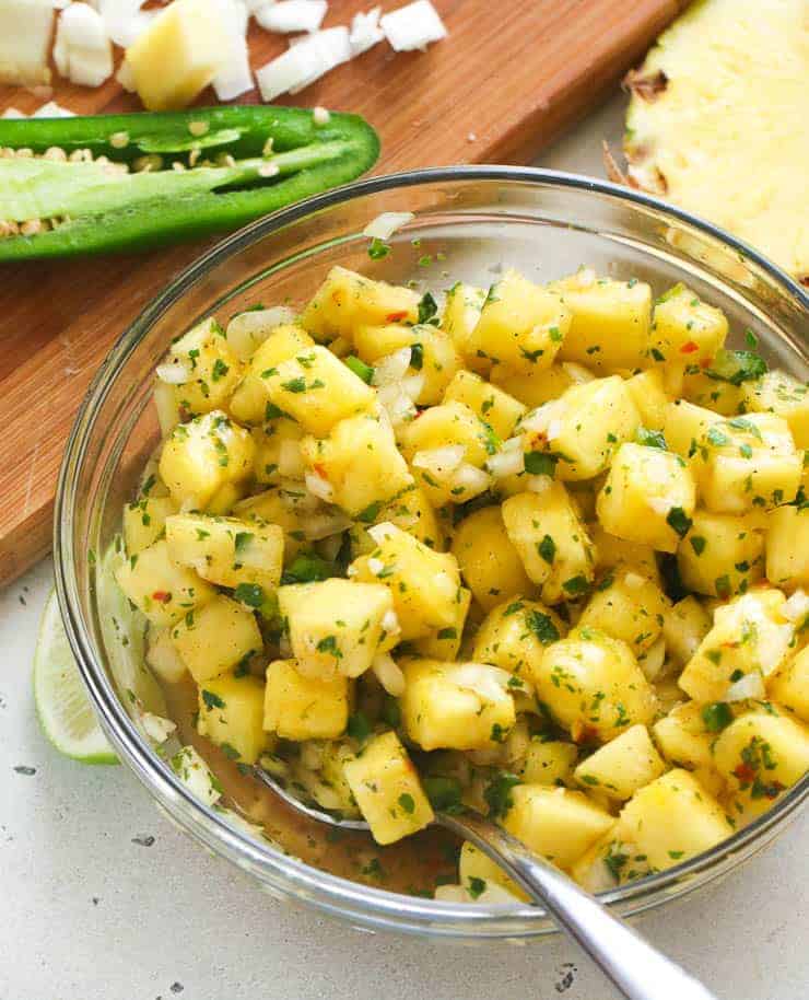 A Bowl of Pineapple Salsa with a Spoon