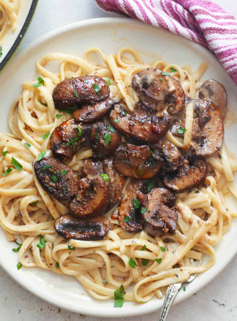 A Plate of Creamy Pasta Topped with Sauteed Mushrooms
