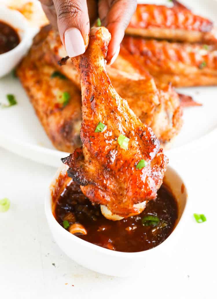 Dipping Baked Turkey Wings in a decadent sweet, sticky sauce