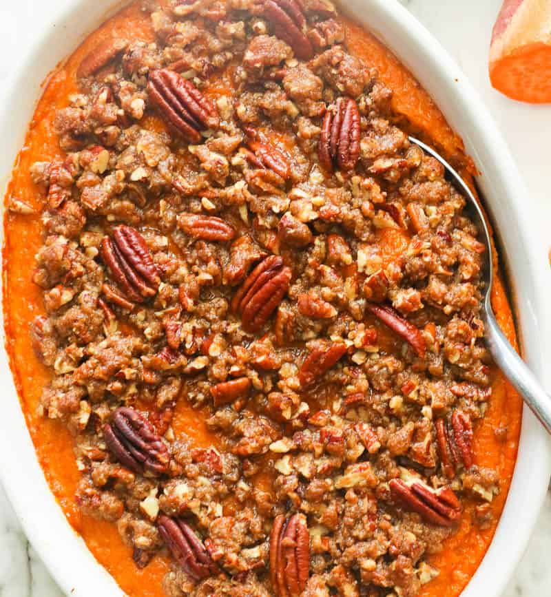 Freshly baked sweet potato casserole with pecans in a baking dish