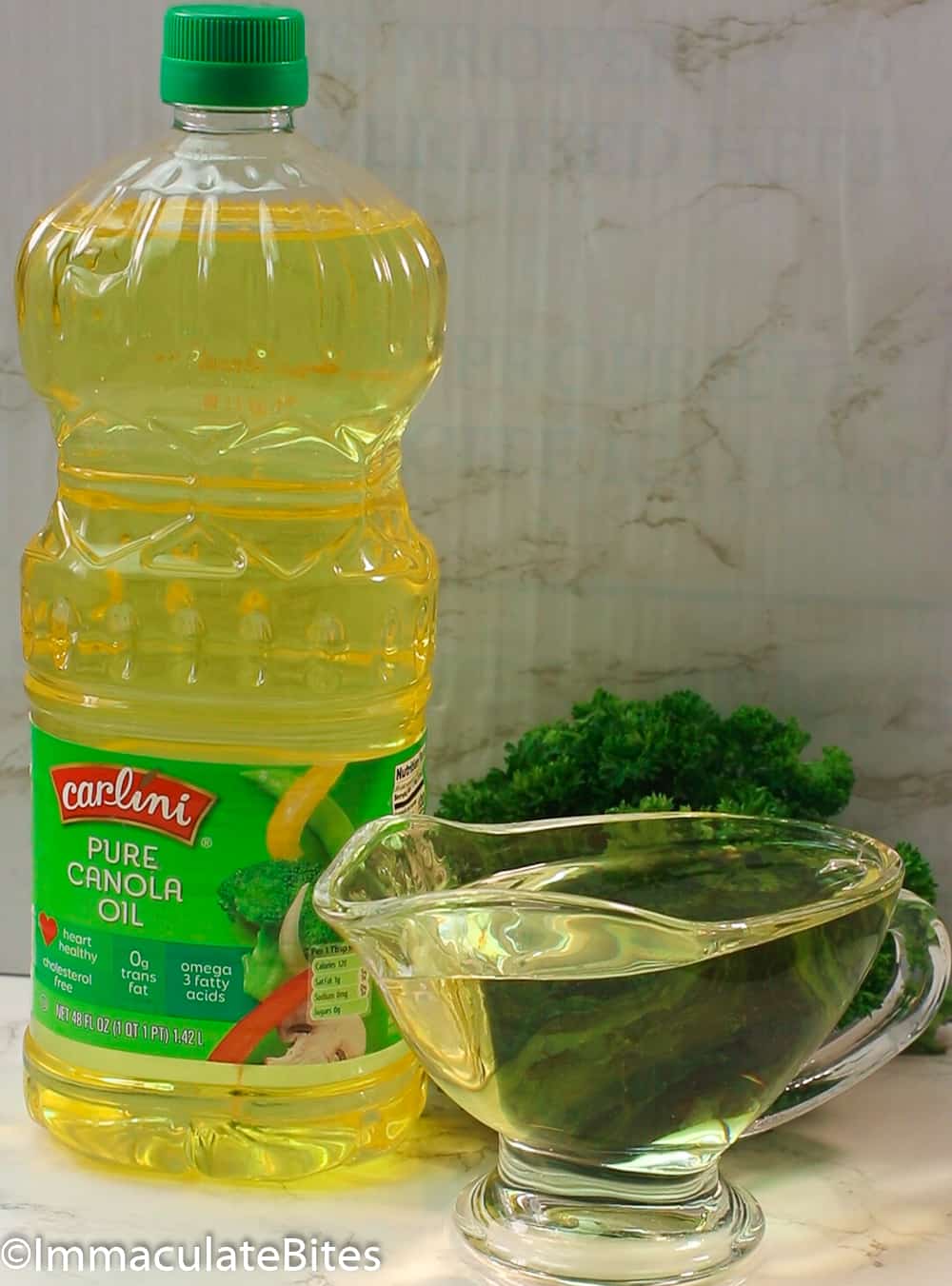 Canola oil in plastic bottle and cup