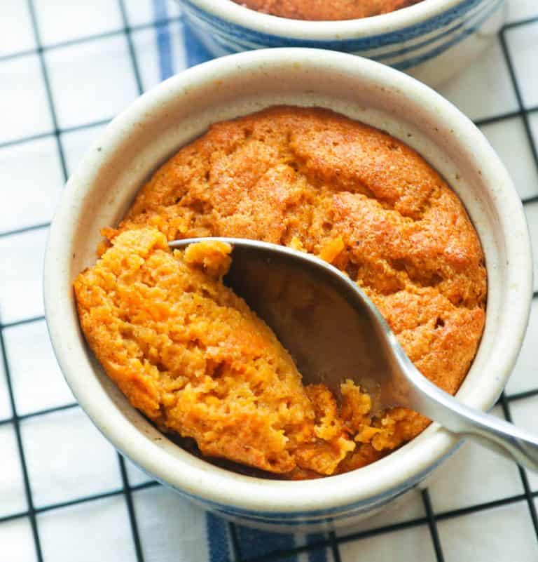Taking a bite of Sweet Potato Souffle bake in a ramekin