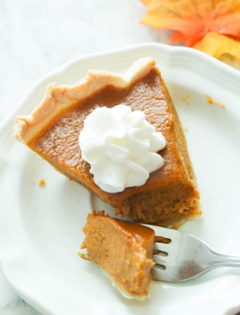 Sliced Pumpkin Pie Topped with Whipped Cream