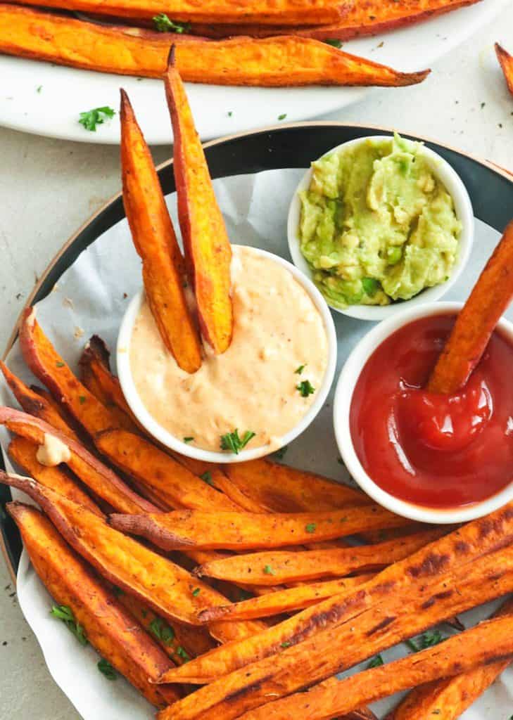 Cajun Baked Sweet Potato Fries Dipped in Remoulade Sauce and Ketchup